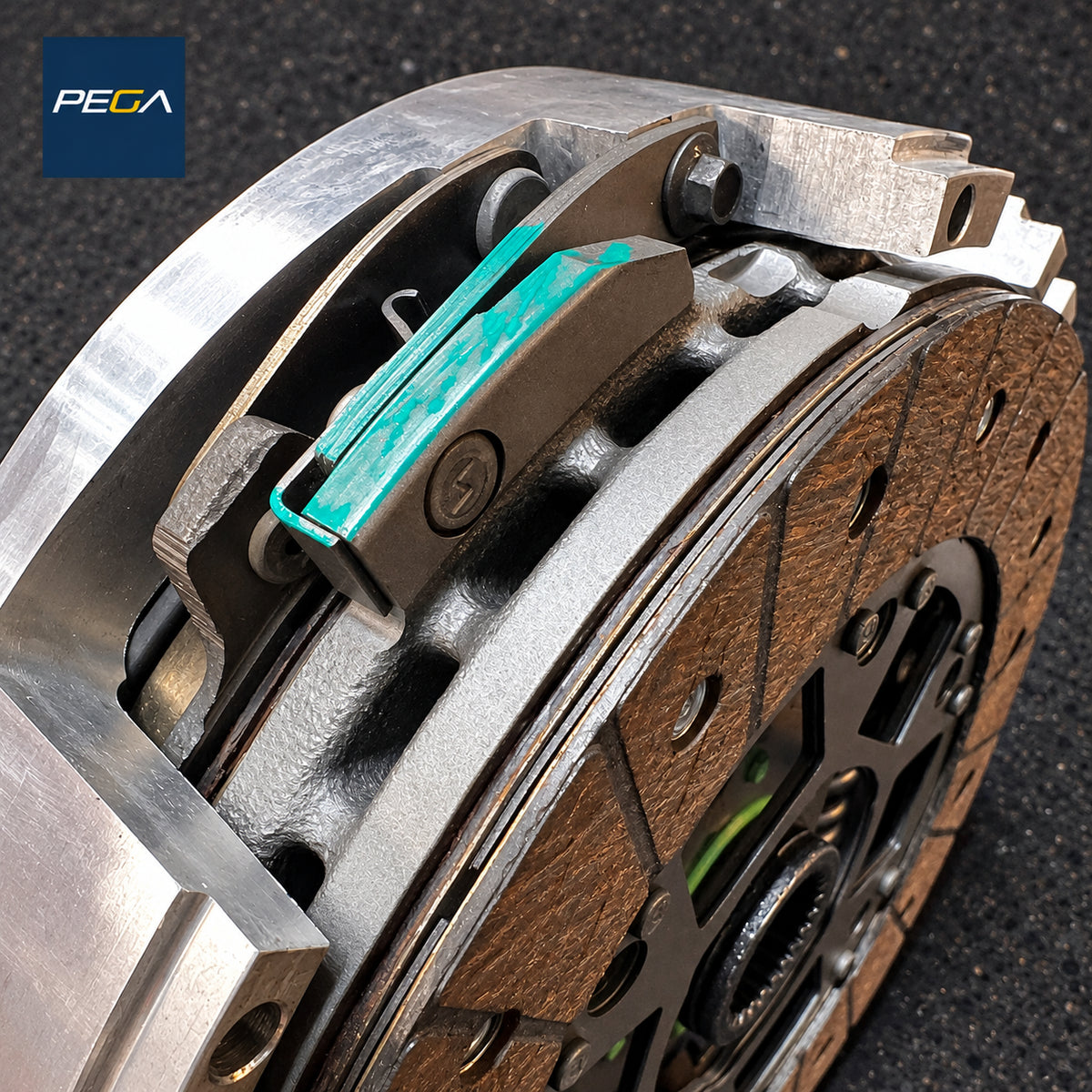 Aston Martin clutch plate-stack service example with friction material, pressure plate and colored witness marks